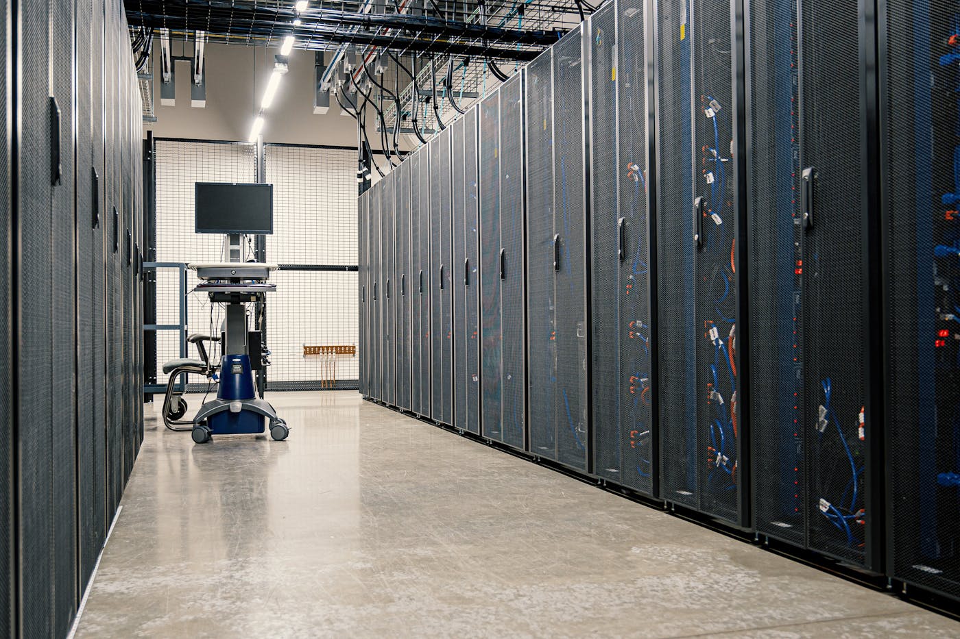 Data center corridor with server racks and equipment used for secure infrastructure.