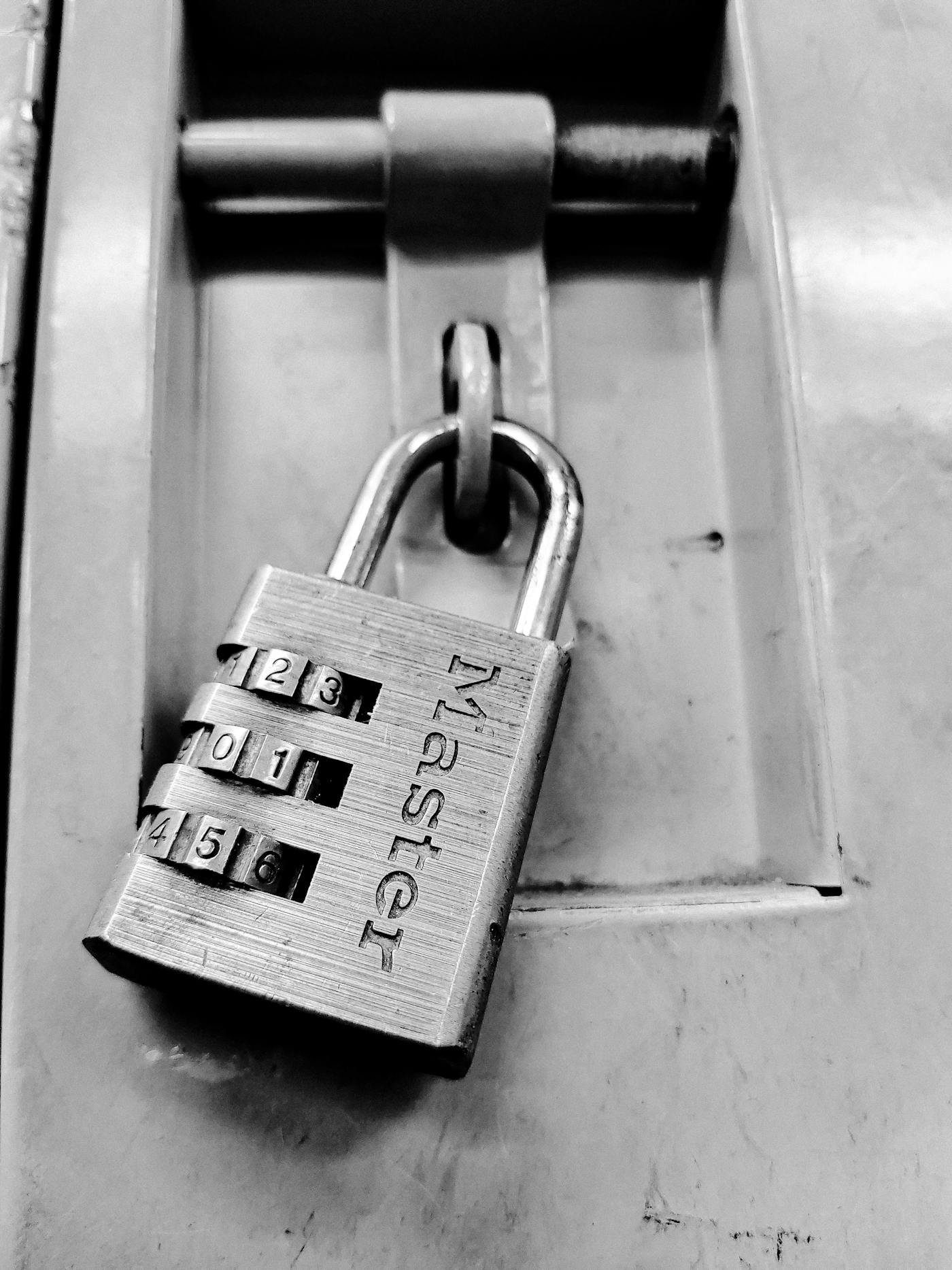 Close-up of a combination padlock securing an access point.